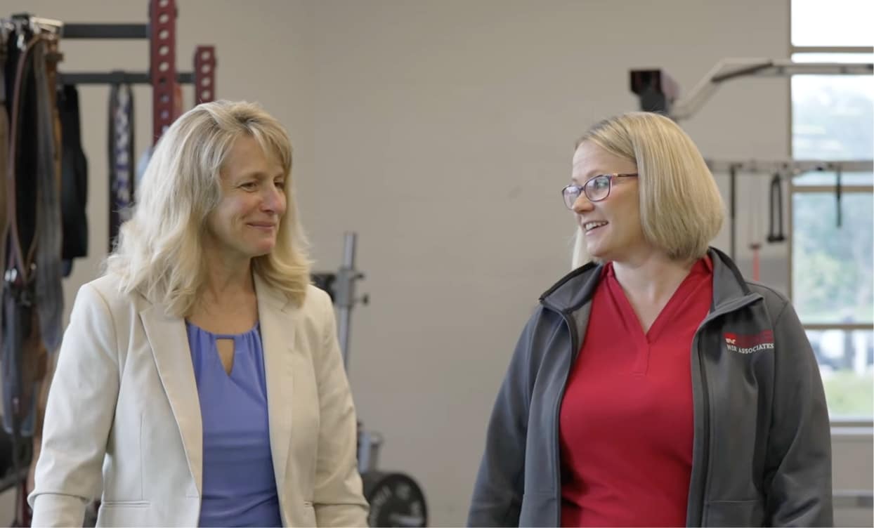 two-talking two women talking in office