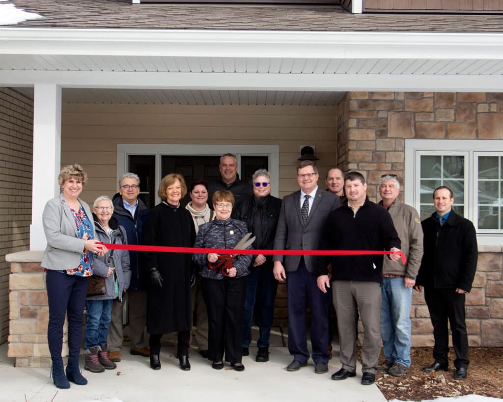 People in front of Alberts House 1 for a ribbon cutting ceremony