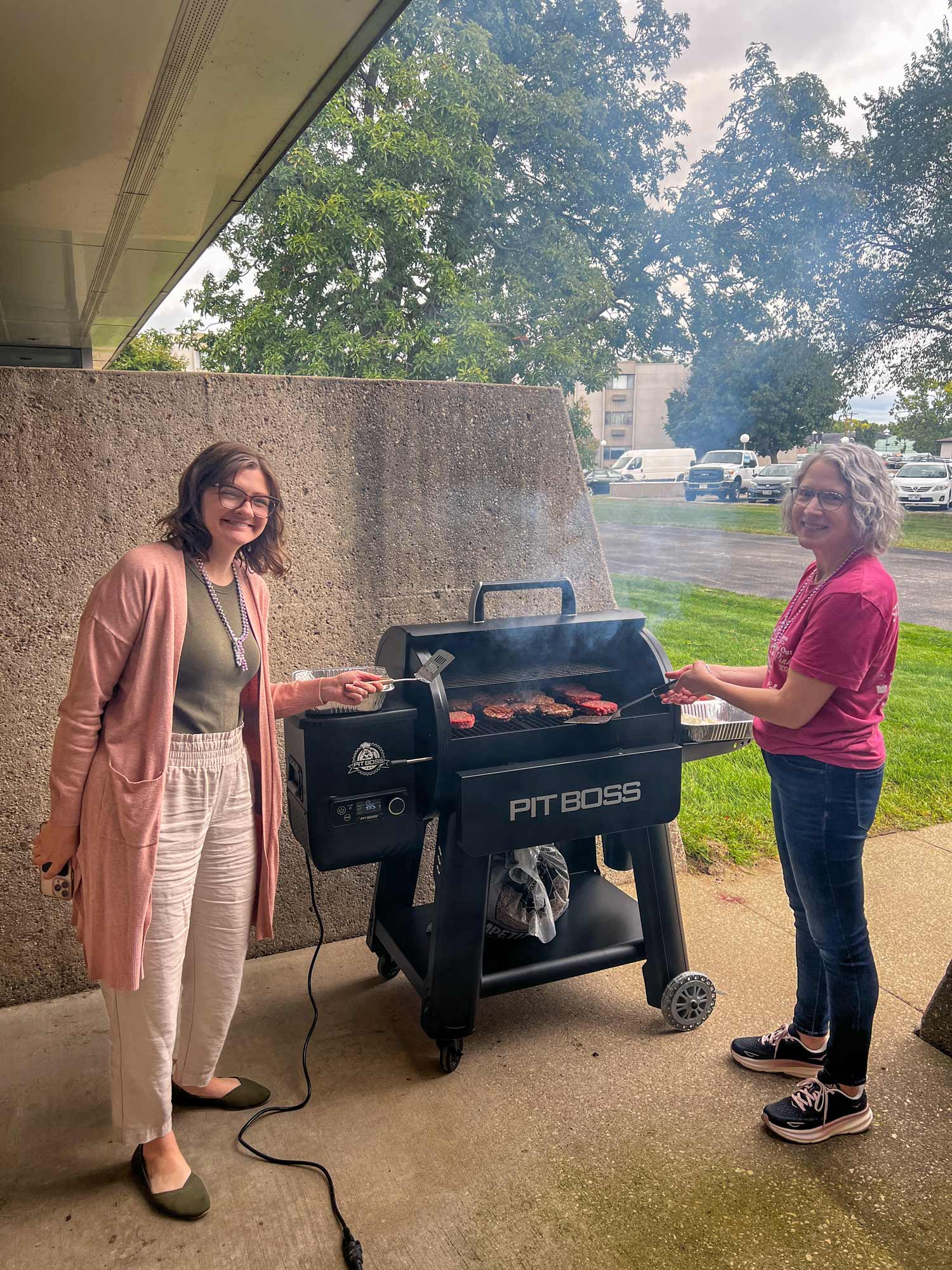 two HSR team members grilling burgers